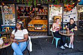 People sitting at Boadway cafe pizza restaurant on a street avenue in Montparnasse Paris France EU Europe