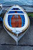 A wooden rowboat hauled out on the ramp in the Marina Grande harbor on the island of Capri, Italy.