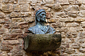 A bust of Dante Alighierei on the tower wall by the House of Dante, now a museum, in Florence, Italy.