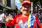 Government supporter appears with Nicolas Maduro's mustache at government march. Supporters of Nicolas Maduro's government celebrate on their platforms, prior to the presidential swearing-in on January 10, 2025.