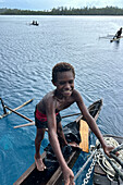 Residents of Tungelo Island in their traditional dugout canoes, New Ireland province, Papua New Guinea