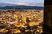 View of the towers of the Badia Fiorentina & Palazzo del Bargello seen from the Palazzo Vecchio tower in Florence, Italy. The shadow of the Palazzo Vecchio tower is projected onto the Palazzo del Bargello.