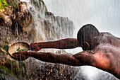 Haiti Voodoo Festival in Saut d'Eau, in Saut d'Eau, Ville Bonheur, Haiti. Thousands of both Vodou and Catholic followers gathered under the Saut d'Eau waterfall in Haiti. The pilgrimage, made by Voodou practitioners and Catholics alike, originated with the sighting of the likeness of the Virgin Mary on a palm leaf close to the falls half a century ago. Catholism and Voodou practices are forever intertwined in its Haitian form. The appearance of a rainbow beneath the falls is said indicate that Danbala - the great lord of the waterfall - and Ayida Wedo - the rainbow - are making love. Fertility