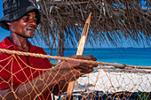 Fisherman fixing the nets in Cayes-à-L’eau, a fishermen islet located northeast of Caye Grand Gosie, Île-à-Vache, Sud Province, Haiti