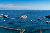 A commercial passenger ferry boat departs from the harbor of the town of Amalfi on the Amalfi Coast in Italy.