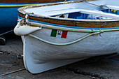 The Italian nautical flag on a rowboat hauled out in Marina Grande on the island of Capri, Italy.