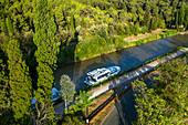 Aerial view of Canal du Midi at Argens Minervois-lock South of France southern waterway waterways holidaymakers queue for a boat trip on the river, France, Europe