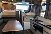 Kitchen inside a boat for a rent in the Canal of Midi trip on the river, France, Europe