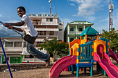 Chindren playing in the children's playground in Jacmel town square in Jacmel city center, Haiti