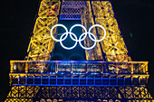 Olympic rings on Eiffel Tower at night, Paris, France