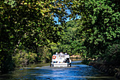 Boat in the Canal du Midi near Carcassonne Aude South of France southern waterway waterways holidaymakers queue for a boat trip on the river, France, Europe