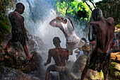 Haiti Voodoo Festival in Saut d'Eau, in Saut d'Eau, Ville Bonheur, Haiti. Thousands of both Vodou and Catholic followers gathered under the Saut d'Eau waterfall in Haiti. The pilgrimage, made by Voodou practitioners and Catholics alike, originated with the sighting of the likeness of the Virgin Mary on a palm leaf close to the falls half a century ago. Catholism and Voodou practices are forever intertwined in its Haitian form. The appearance of a rainbow beneath the falls is said indicate that Danbala - the great lord of the waterfall - and Ayida Wedo - the rainbow - are making love. Fertility