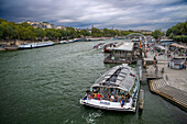 Passenger touristic cruise ship in the Seine river is moored to the pier near Eiffel Tower