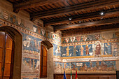 Medieval frescoes in the Sala di Dante of the 13th Century Palazzo Comunale or city hall in San Gimignano, Italy.