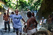 Haiti Voodoo Festival in Saut d'Eau, in Saut d'Eau, Ville Bonheur, Haiti. Thousands of both Vodou and Catholic followers gathered under the Saut d'Eau waterfall in Haiti. The pilgrimage, made by Voodou practitioners and Catholics alike, originated with the sighting of the likeness of the Virgin Mary on a palm leaf close to the falls half a century ago. Catholism and Voodou practices are forever intertwined in its Haitian form. The appearance of a rainbow beneath the falls is said indicate that Danbala - the great lord of the waterfall - and Ayida Wedo - the rainbow - are making love. Fertility