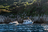 A tour boat traffic jam at the Blue Grotto on the island of Capri, Italy.