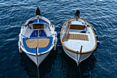 Fishing boats moored in the small harbor of the fishing village of Manarola, Cinque Terre, Italy.