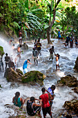 Haiti Voodoo Festival in Saut d'Eau, in Saut d'Eau, Ville Bonheur, Haiti. Thousands of both Vodou and Catholic followers gathered under the Saut d'Eau waterfall in Haiti. The pilgrimage, made by Voodou practitioners and Catholics alike, originated with the sighting of the likeness of the Virgin Mary on a palm leaf close to the falls half a century ago. Catholism and Voodou practices are forever intertwined in its Haitian form. The appearance of a rainbow beneath the falls is said indicate that Danbala - the great lord of the waterfall - and Ayida Wedo - the rainbow - are making love. Fertility