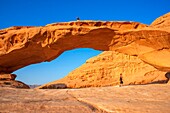 Hiking at rock-arch Al Kharza or Al Borg Alsagheer Wadi Rum, Jordan