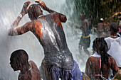 Haiti Voodoo Festival in Saut d'Eau, in Saut d'Eau, Ville Bonheur, Haiti. Thousands of both Vodou and Catholic followers gathered under the Saut d'Eau waterfall in Haiti. The pilgrimage, made by Voodou practitioners and Catholics alike, originated with the sighting of the likeness of the Virgin Mary on a palm leaf close to the falls half a century ago. Catholism and Voodou practices are forever intertwined in its Haitian form. The appearance of a rainbow beneath the falls is said indicate that Danbala - the great lord of the waterfall - and Ayida Wedo - the rainbow - are making love. Fertility