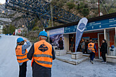 Tourists get geared up with hard hats and safety vests to visit a marble quarry on a tour in Carrara, Italy.