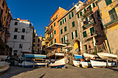 Boats stacked out of the water by the harbor in Riomaggiore, Cinque Terre, Italy.