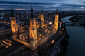 Aerial view of the Cathedral Basilica of of Our Lady of the Pillar and El Pilar square illuminated at night during Christmas, Zaragoza, Spain