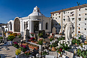 Flowers decorate the graves in a cemetery in Anacapri on the island of Capri, Italy.