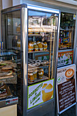 A freezer in a shop with coconut gelato and lemon sorbet for sale in Anacapri on Capri, Italy.