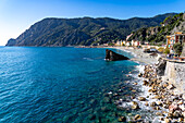 The Fegina beach in off peak season in Monterosso al Mare, Cinque Terre, Italy, with the Scoglio Malpasso or Malpasso Rock.