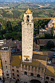 Torre Rognosa or Rognosa Tower on Piazza del Duomo in the medieval walled town of San Gimignano, Italy. At left is the shorter Torre Chigi.