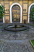 Mosaic designs in the walkway around a fountain in the gardens of the Palazzo Medici Riccardi. Florence, Italy.