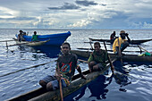 Residents of New Hanover island in their traditional dugout canoes, New Ireland province, Papua New Guinea