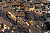 Traditional clay tile rooftops of the medieval buildings in the walled city of San Gimignano, Italy.