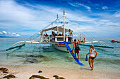 Traditional boats moored off a tiny tropical island beach in the Philippines Kalanggaman island, Malapascua, Cebu, Philippines