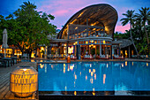 Swimming pool and restaurant of the Outrigger maldives Maafushivaru luxury resort, South Ari Atoll region Maldives