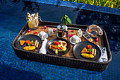 Floating breakfast in the pool in the The residence luxury resort, Bintan island, Riau islands, Indonesia