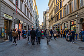 Pedestrians on the Via del Calzaiuoli in historic Florence, Italy.