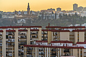 Skyline of Seville featuring iconic monuments and contrasting modern residential housing.