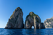 The Farallons or faraglioni, sea stacks off the coast of the island of Capri, Italy. L-R: Scopolo or Fuori & Mezzo, with its sea arch.