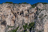 Stalactites in grottos in the limestone cliffs on the coast of the island of Capri, Italy.