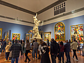 Tourists and the Rape of the Sabine Women by Giambolgna in the Accademia Gallery in Florence, Italy.