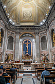 Worshippers in the Chapel of the Blessed Sacrament in the Basilica of St. Paul Outside the Walls, Rome, Italy.