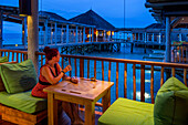 Relaxing in the bar restaurant of the Six Senses Laamu maldives luxury resort villas, Laamu Atoll region Maldives