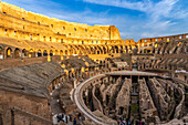 Interior of the Roman Colosseum or Flavian Amphitheater with golden sunset light in Rome, Italy. The tunnels under the floor of the arena were called hypogeum.