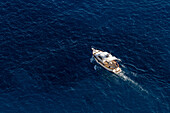 A pleasure boat in the waters of the Tyrrhenian Sea off the coast of the island of Capri, Italy.