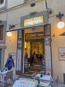 Doorway to a restaurant advertising gluten-free pizza and pasta in Florence, Italy.