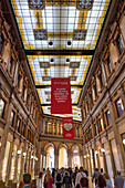 Tourists in the Galleria Albero Sordi shopping mall. Rome, Italy.