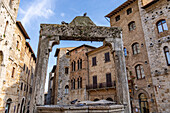 Der Palazzo Tortoli umrahmt von der Zisterne auf der Piazza della Cisterna in der ummauerten Stadt San Gimignano, Italien.