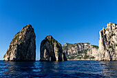 The Farallons or faraglioni, sea stacks off the coast of the island of Capri, Italy. L-R: Scopolo or Fuori, Mezzo with its sea arch & Stella. The town of Marina Piccola is visible between Mezzo and Stella.